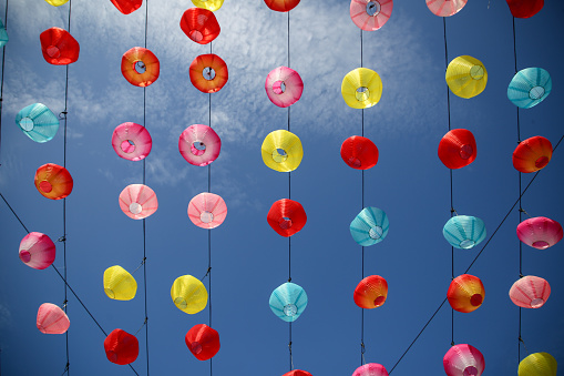 Focus scene on Chinese New Year decorations - pastel coloured lanterns in temple