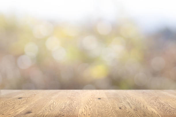 istock Wooden table background image with wood grain on sparkling background with ball blur 1959240171