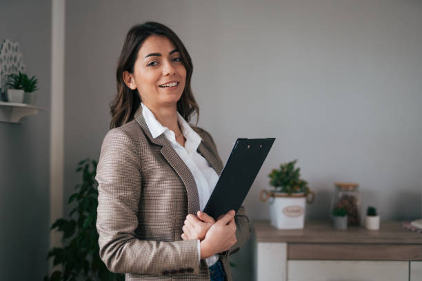 istock Businesswoman standing and holding a folder 1959242787