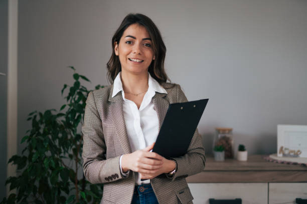 istock Businesswoman standing and holding a folder 1959243314