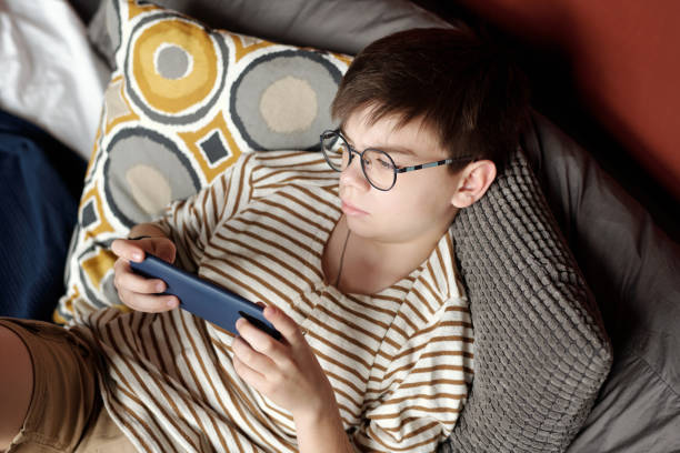 istock Boy looking at screen of smartphone 1959257325