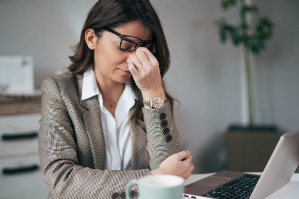 istock A young woman works at home and has a headache 1959259952