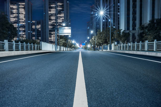 istock New asphalt road and cityscape at night 1959263588