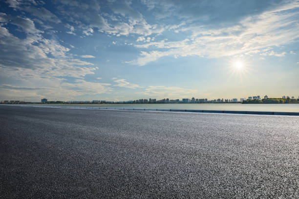 istock Empty asphalt road and city skyline background 1959269795