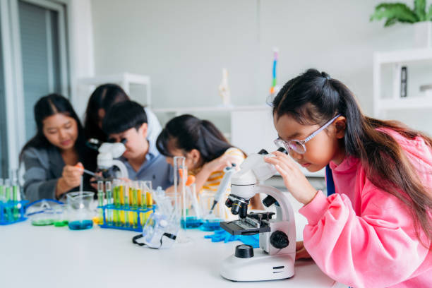 Close up of Primary class children engaged in hands-on scientific experiments. Students discovering the wonders of science through interactive and engaging experiments.