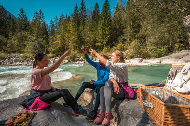 istock Diverse Friends Enjoying Picnic During Forest Hike 1959295473