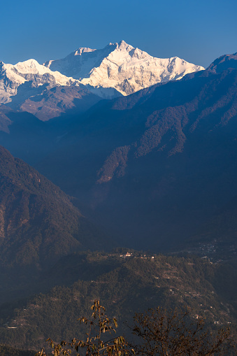 Portrait  view of Snow clad Kangchenjunga, also spelled Kanchenjunga, with Mountain Layers.