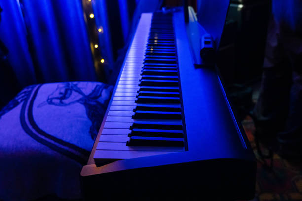 istock Piano keyboard in concert filled with light. selective focus modern piano, close up, studio light 1959305268