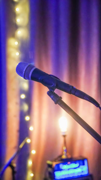 istock Microphone and stage light. Public performance on stage Microphone on stage against a background of auditorium. Shallow depth of field. 1959305795