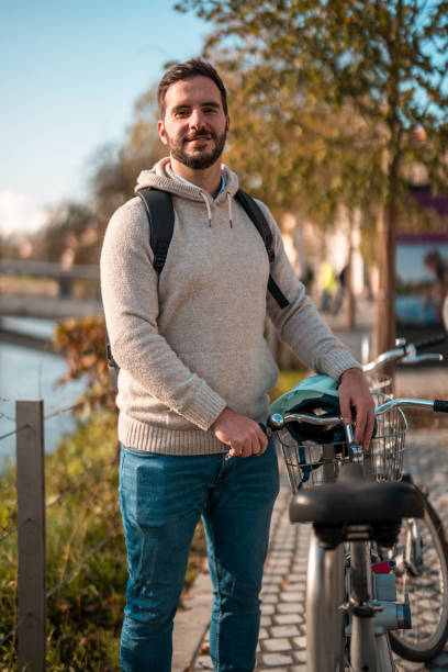 istock Smiling Caucasian Man with Bicycle in Urban Setting 1959305810