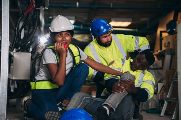 istock Team Engineers calls for assistance after a team member sustains a leg injury while doing electrical work. Technician in inverter solar panel room. 1959321945