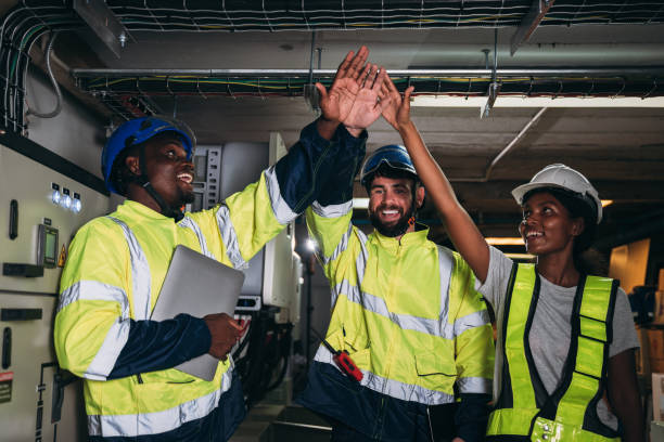istock Team engineers and foreman stack hand and shake hands to show success at inverter solar panel room. Worker industry join hand for collaboration. 1959323519