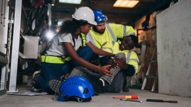 istock Team Engineers calls for assistance after a team member sustains a leg injury while doing electrical work. Technician in inverter solar panel room. 1959326712