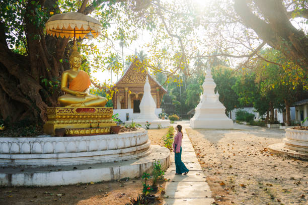 Woman exploring buddhist temple in Laos