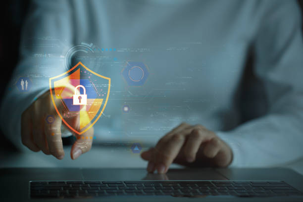 istock Safeguard for digital assets. Tech savvy businessman guards data with digital shield on laptop, Secure network, impenetrable defense. Cyber security concept. 1959353869