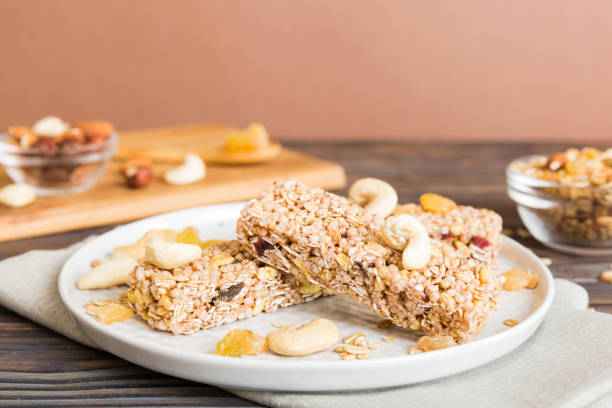 istock Various granola bars on table background. Cereal granola bars. Superfood breakfast bars with oats, nuts and berries, close up. Superfood concept 1959362833