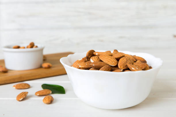 istock Fresh healthy Almond in bowl on colored table background. Top view 1959363886