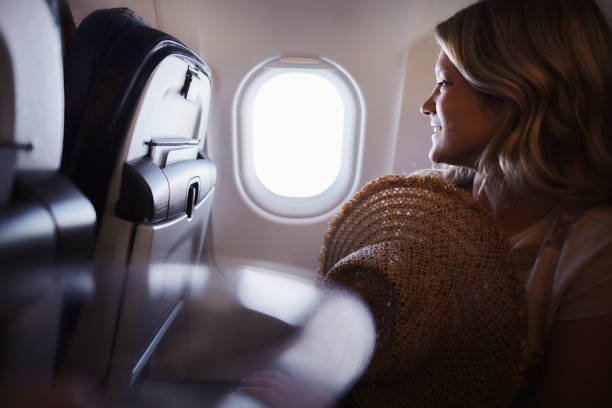 istock Young happy woman traveling by plane. 1959366571