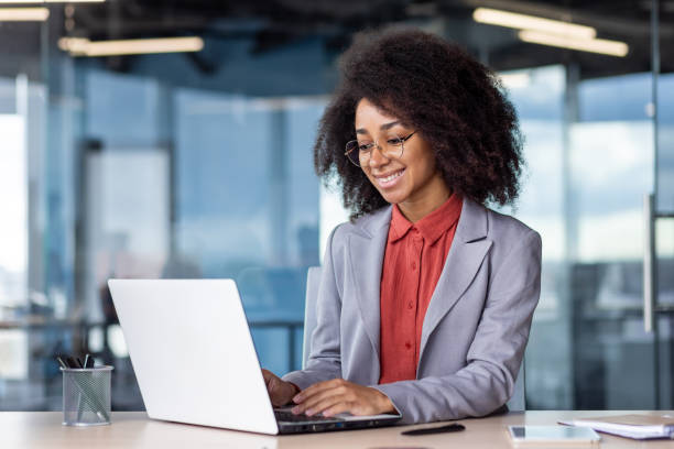 istock Young smiling African American female student studying on campus at desk using laptop 1959377769