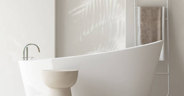 istock White round side table by bathtub in luxury design bathroom in sunlight, palm leaf shadow on wall 1959403968