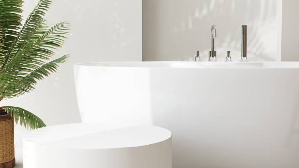 istock White round side table, bathtub, tropical palm tree in luxury design bathroom in sunlight, leaf shadow on wall 1959411363