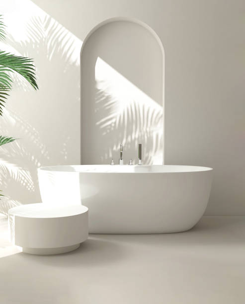 istock White round side table, bathtub, tropical palm tree in luxury design bathroom in sunlight, leaf shadow on cream wall 1959411365