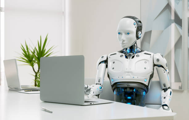 istock A humanoid robot works in an office on a laptop 1959425089