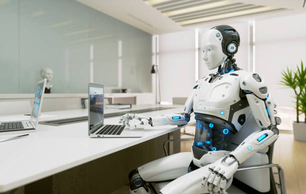 istock Android AI robot sitting at the desk and working in the office 1959425092