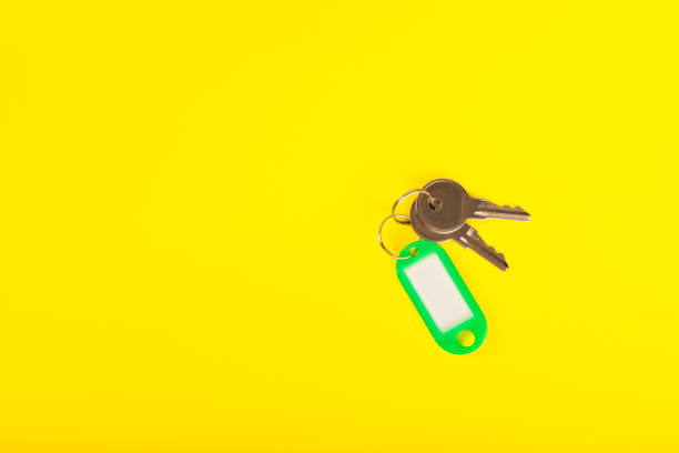 istock Plastic key ring in different colors with a place for a signature on a bright colored background. Bunch of keys with keychain. Mock-up keychain.Copy space.Concept for renting and selling real estate. 1959449372