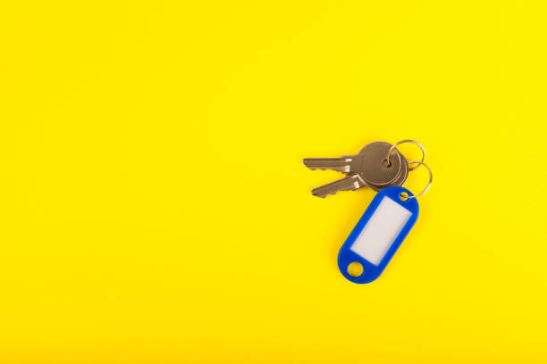istock Plastic key ring in different colors with a place for a signature on a bright colored background. Bunch of keys with keychain. Mock-up keychain.Copy space.Concept for renting and selling real estate. 1959449375