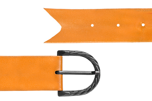 Old leather belt with metal buckle lying in front of a white background