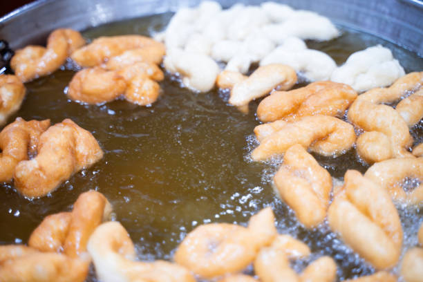Patongko is being fried in a large pan. Breakfast for early risers.