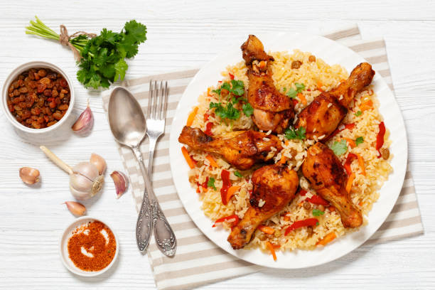 istock fried chicken drumsticks over rice pilaf, top view 1959483849