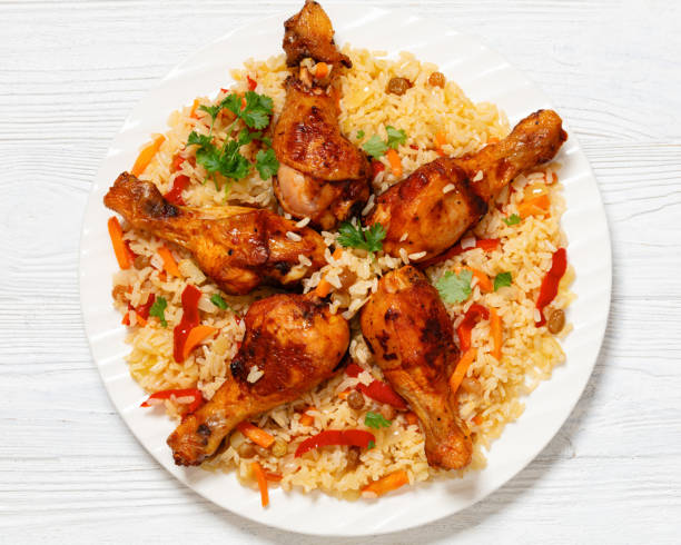 istock fried chicken drumsticks over rice pilaf, top view 1959484356