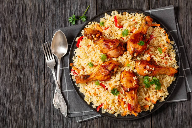 fried chicken drumsticks over rice pilaf, top view