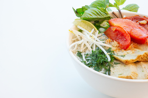Above view of Vietnamese ham pho noodle vermicelli soup with bean sprout on white background