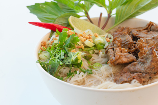 Vietnamese satay beef pho noodle soup on white background