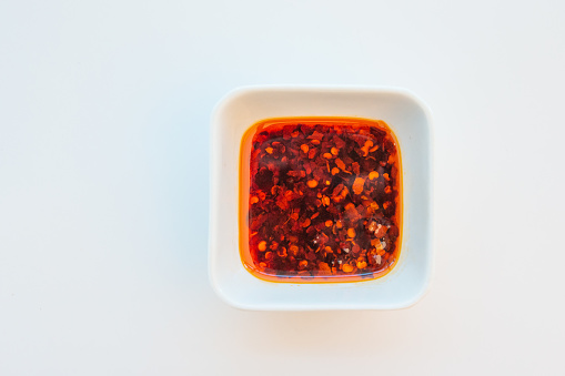 Asian oil hot chili hot sauce dipping bowl on white background