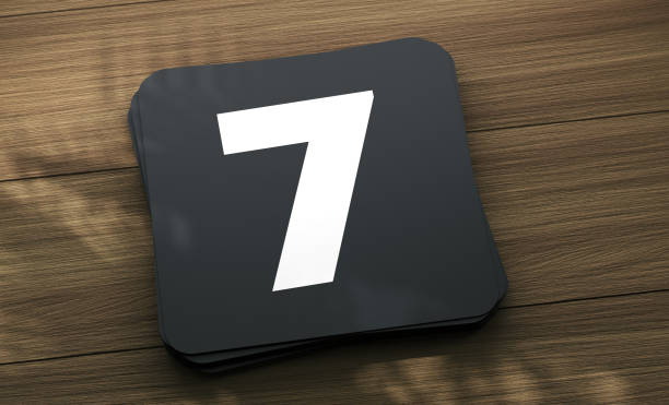 Placard with the number 7 on the wooden table. Finance Concept.