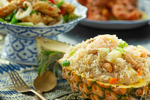 Restaurant Savory seafood fried rice served in cut out pineapple fruit