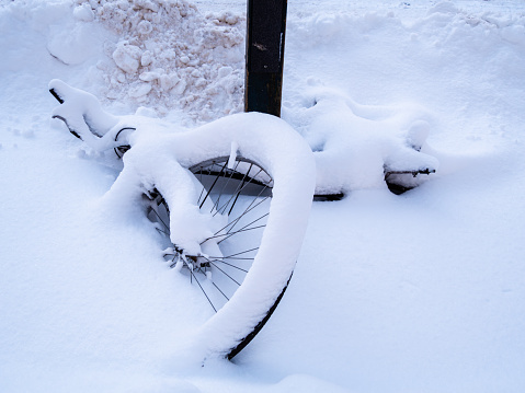 Stockholm, Sweden - March 9, 2023: Snowed up and abandoned bicycle in the tourist island in the center of Stockholm
