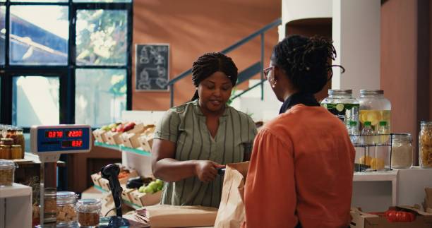 istock African american client paying for organic food using card 1959529340