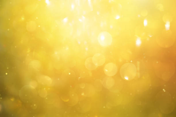 istock Defocused yellow bokeh background with floating particles 1959532052