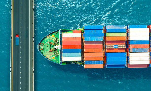 istock Aerial view of container shipping system. and container trucks running on the bridge international transportation Export-import business, logistics, transportation industry, bridge concept 1959535231