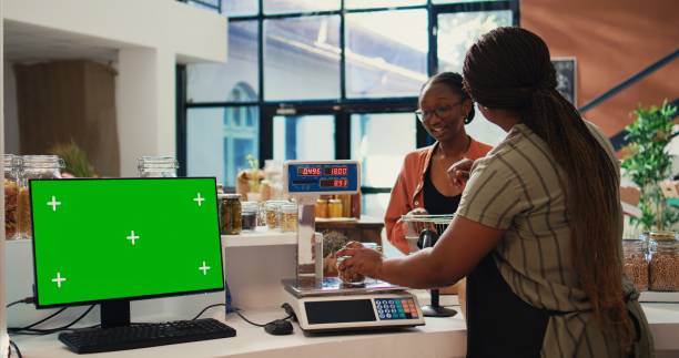 istock Buyer approaching checkout next to greenscreen display 1959536277