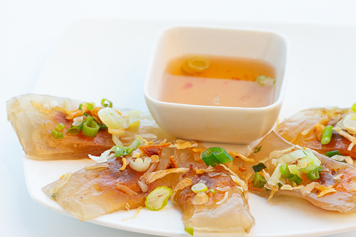 Vietnamese translucent shrimp pork dumpling with fish sauce dipping on white background
