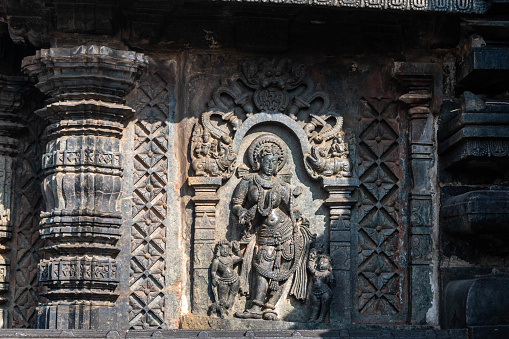 Beautiful ornate carving of a figurine on the wall of the ancient Chennakeshava temple in Belur.