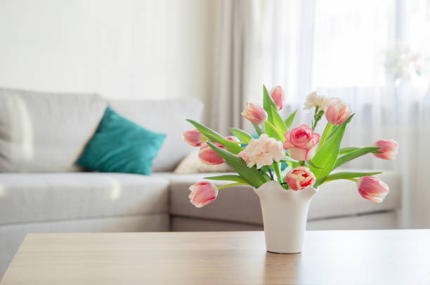 istock pink spring flowers in white ceramic vase in modern home interior 1959559064