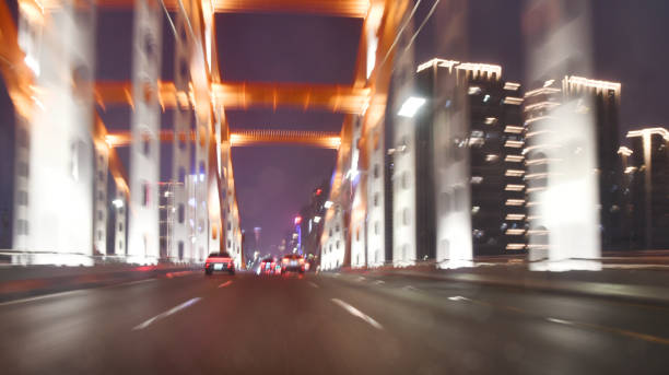 Speedy drive on steel bridge on rainy night  in city