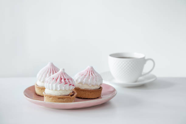 istock cupcakes with cup of coffee on white table 1959560689